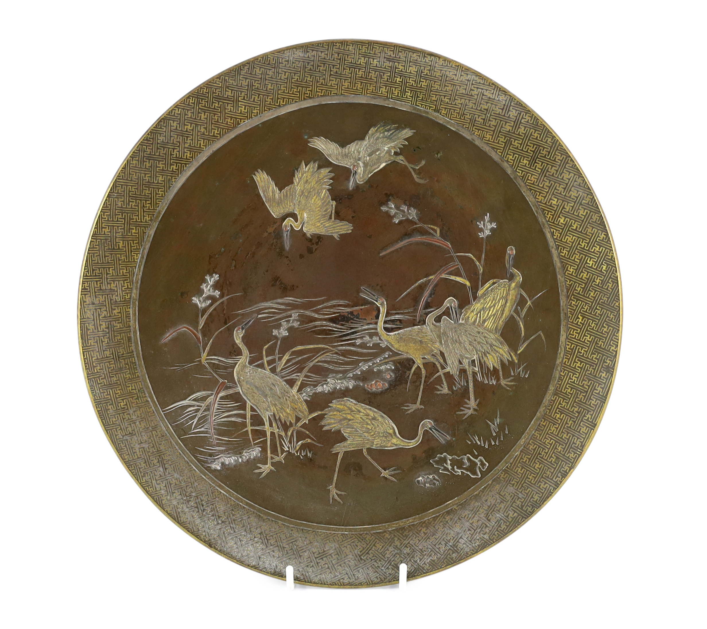 A Japanese Komai style mixed metal inlaid bronze dish, Meiji period